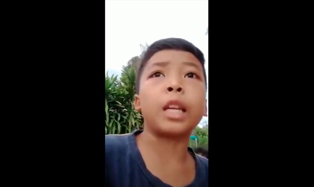 A screenshot from the viral video showing Mohamad Haziq giving his report. – Facebook