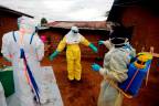 FILE PHOTO: Kavota Mugisha Robert, a healthcare worker, who volunteered in the Ebola response, decontaminates his colleague after he entered the house of 85-year-old woman, suspected of dying of Ebola, in the eastern Congolese town of Beni in the Democratic Republic of Congo, October 8, 2019. - REUTERSPIX