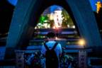 Visitors pray for the atomic bomb victims in front of the cenotaph at the Hiroshima Peace Memorial Park in Hiroshima early on August 6, 2022 to mark 77 years since the world’s first atomic bomb attack/AFPPix