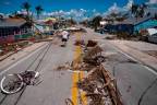 A man walks pass debris scattered on Pine Island Road in the aftermath of Hurricane Ian in Matlacha, Florida on October 1, 2022/AFPPix