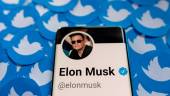 FILE PHOTO: FILE PHOTO: Elon Musk's Twitter profile is seen on a smartphone placed on printed Twitter logos in this picture illustration taken April 28, 2022. - REUTERSPIX