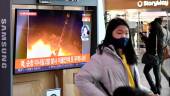 People walk past a television screen showing a news broadcast with file footage of a North Korean missile test, at a railway station in Seoul on January 27, 2022, after North Korea fired an “unidentified projectile” in the country’s sixth apparent weapons test this year according to the South’s military. AFPPIX