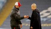 FILE PHOTO: Manchester City manager Pep Guardiola (right) and Liverpool manager Jurgen Klopp (left) bump fists after the match at the Etihad Stadium in Manchester on November 8, 2020. REUTERSPIX