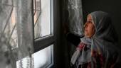 Samira , 43 year-old, who came from Damascus, looks out from a window of her flat in Sanliurfa on May 17, 2022. AFPPIX