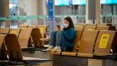 FILE PIX: A woman looks at a phone at Incheon international airport on December 29, 2020, amid the Covid-19 coronavirus pandemic. AFPPIX