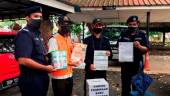KOTA BHARU, April 23 - Kelantan Social Welfare Department (JKM) Senior Assistant Director of Enforcement Division, Mohamad Md Nor (second, left) shows ‘props’ used by beggars in the state who were detained through the state JKM Integrated Operation at the state JKM Office. BERNAMAPIX
