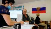 A man fills document to apply for new Russian passport at a centre in Melitopol in Zaporizhzhia region, on August 3, 2022, amid the ongoing Russian military action in Ukraine. AFPPIX
