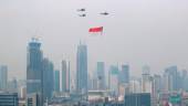 Indonesian Air Force helicopters carrying a big flag fly above high rise buildings during the country’s 76th Independence Day celebrations in Jakarta, Indonesia, August 17, 2021. -REUTERSpix