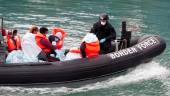 FILE PHOTO: Border Patrol agents bring migrants into Dover harbour on a boat, after they tried to cross the channel, in Dover, Britain, September 7, 2020. - REUTERSPIX