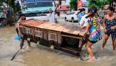 Residents carry an animal cage while evacuating from their submerged homes in the aftermath of Super Typhoon Noru in San Ildefonso, Bulacan province on September 26, 2022. AFPPIX