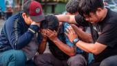 People grieve for victims of the stampede at Kanjuruhan stadium in Malang, East Java on October 4, 2022. AFPPIX