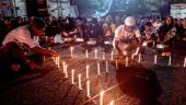 People and football supporters hold candlelight vigil for victims of a stampede at Kanjuruhan stadium in Malang/AFPPIX