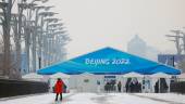 A man walks amid snowfall outside an entrance to the closed loop bubble surrounding venues of the Beijing 2022 Winter Olympics in Beijing, China January 20, 2022. REUTERSpix