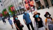 People wearing protective face masks walk on a street, following new cases of the coronavirus disease (Covid-19), in China. REUTERSpix