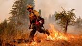 A firefighter walks while battling flames at Volcanoville, California, U.S. September 9, 2022. - REUTERSPIX
