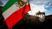 A man holds a flag during a protest following the death of Mahsa Amini in Iran, in front of the Brandenburg Gate, in Berlin, Germany, September 28, 2022. REUTERSPIX