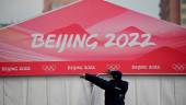 A worker is seen at the entrance of the Wukesong Sports Centre, venue for the ice hockey competition during the 2022 Beijing Winter Olympics, in Beijing on January 18, 2022. AFPPIX