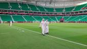 (FILES) In this file photo taken on October 22, 2021 Qatari officials walk on the pitch ahead of the Al-Thumama Stadium in the capital Doha. Qatar World Cup ticket sales were launched at reduced prices on January 19, 2022 with residents and migrant workers able to attend games for just $11 as concerns persist over Covid-19. AFPPIX