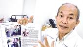Wong showing an article about his service in the army. – Adib Rawi Yahya/theSun