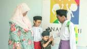 Ahmad Jamali (right) sharing a light moment with his two brothers while his adoptive mother looks on. – ADIB RAWI YAHYA/THESUN