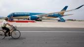 A security guard cycles near an Airbus A350-900 aircraft during its delivery ceremony at Noi Bai International Airport in Hanoi July 2, 2015. REUTERSPIX