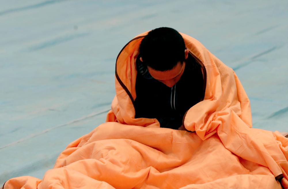 A man rests in an evacuation centre, in the aftermath of Typhoon Hagibis which caused severe floods, in Nagano Prefecture, Japan, Oct 14, 2019. — Reuters