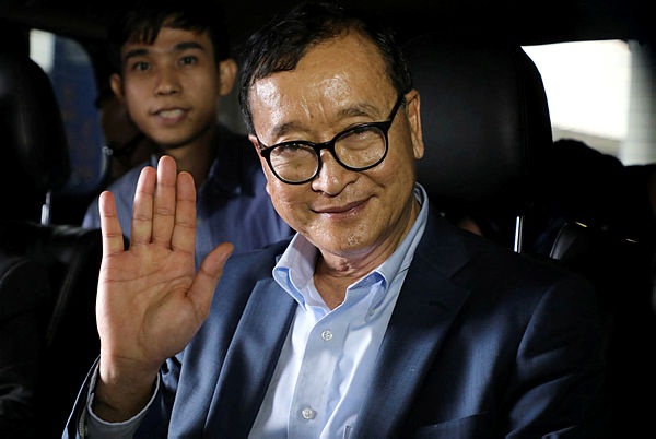 Cambodia’s self-exiled opposition party founder Sam Rainsy waves before he leaves Kuala Lumpur International Airport in Sepang, Malaysia, November 9, 2019. — Reuters