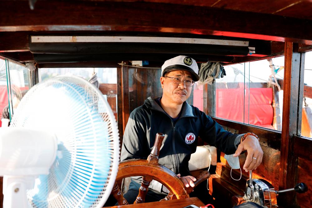 $!Kwok Wah-hei, captain of the traditional wooden tourist junk boat “Dukling”, is seen onboard, during the COVID-19 pandemic, in Hong Kong, China October 31, 2020. Picture taken October 31, 2020. REUTERS/Tyrone Siu