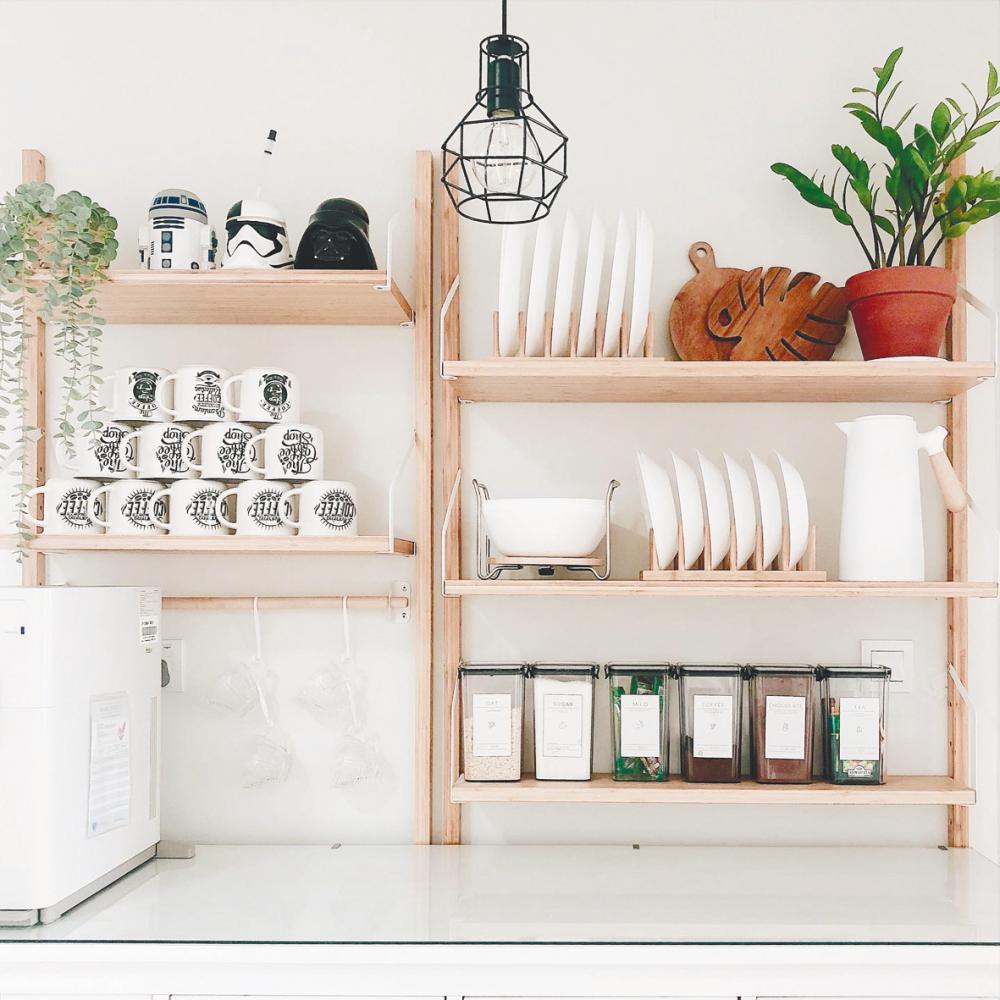 $!A bright and airy kitchen with open shelves is simple. Plates and cups are arranged beautifully.