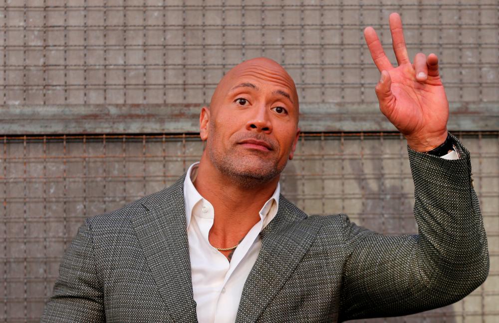 FILE PHOTO: Cast member Dwayne Johnson poses at the premiere for the movie Rampage in Los Angeles, California, US, April 4, 2018. - Reuters