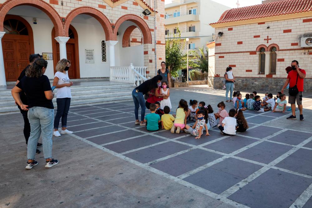 Students and their teachers are seen at a square following an earthquake in Heraklion, on the island of Crete, Greece, September 27, 2021. REUTERSpix