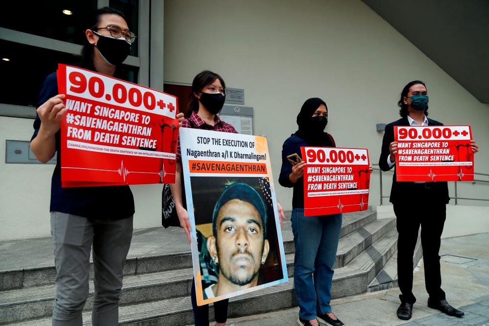 Activists hold placards and a poster against the imminent execution of Nagaenthran Dharmalingam, who was sentenced to death for drug trafficking in Singapore, outside the Singapore High Commission in Kuala Lumpur, Malaysia November 23, 2021. REUTERSpix
