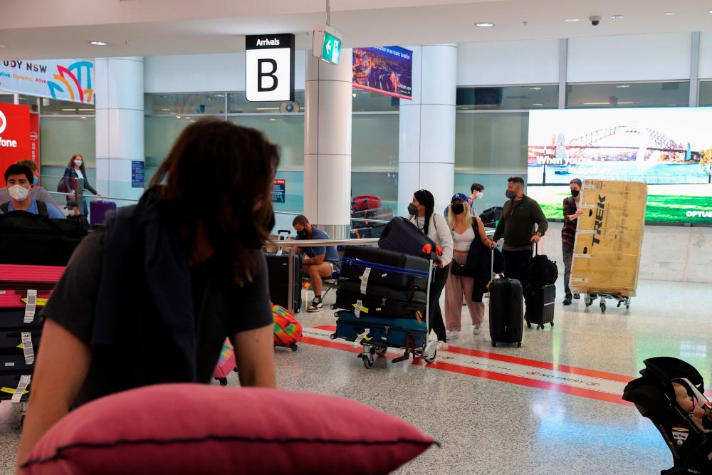 Travellers arrive at the international terminal at Sydney Airport, as countries react to the new coronavirus Omicron variant amid the coronavirus disease (COVID-19) pandemic, in Sydney, Australia, November 30, 2021. -ReutersPix
