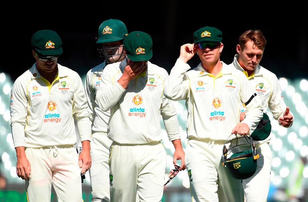 Cricket - Ashes - Second Test - Australia v England - Adelaide Oval, Adelaide, Australia - December 20, 2021, Australia players walk off the pitch for lunch. - REUTERSPIX