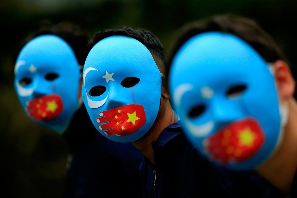 Activists take part in a protest against China’s treatment towards the ethnic Uyghur people and calling for a boycott of the 2022 Winter Olympics in Beijing, at a park Jakarta, Indonesia, January 4, 2022. REUTERSPIX