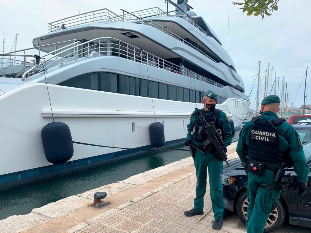 Spanish Civil Guards stand by the Tango superyacht, belonging to Russian oligarch Viktor Vekselberg, which was seized on behalf of U.S. authorities, as it is docked at the Mallorca Royal Nautical Club, in Palma de Mallorca, in the Spanish island of Mallorca, Spain/REUTERSPix