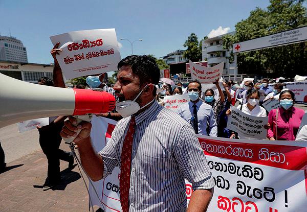 Government Medical Officers’ Association members walk with placards protesting against Sri Lankan President Gotabaya Rajapaksa after his government lost its majority in the parliament during a demonstration near the parliament building in Colombo, Sri Lanka. - REUTERSPIX