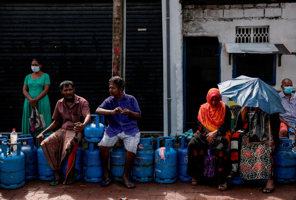 People wait in a line to buy domestic gas tanks near a distributor, amid the country’s economic crisis, in Colombo, Sri Lanka, May 23, 2022. REUTERSPIX