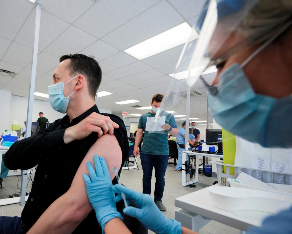 FILE PHOTO: A man is vaccinated at a monkeypox vaccination clinic run by CIUSSS public health authorities in Montreal, Quebec, Canada, June 6, 2022. REUTERSPIX