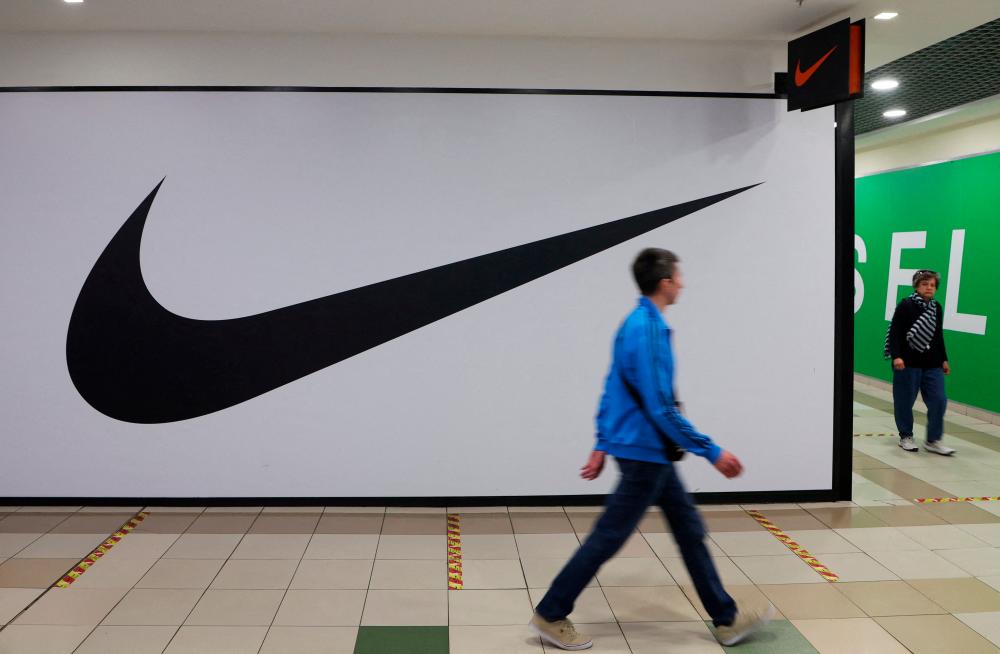 People walk past a closed store of the sporting goods retailer Nike at a shopping mall in Saint Petersburg, Russia May 25, 2022. REUTERSPIX