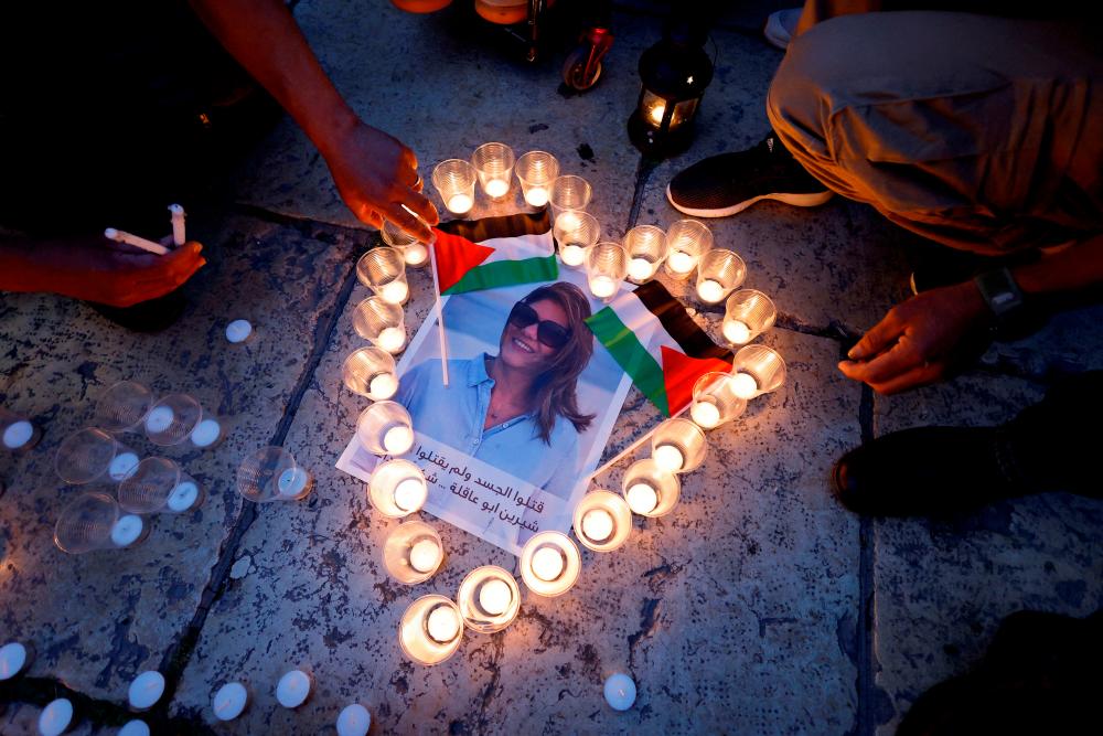 People light candles during a vigil in memory of Al Jazeera journalist Shireen Abu Akleh, who was killed during an Israeli raid, outside the Church of the Nativity in Bethlehem/REUTERSPix