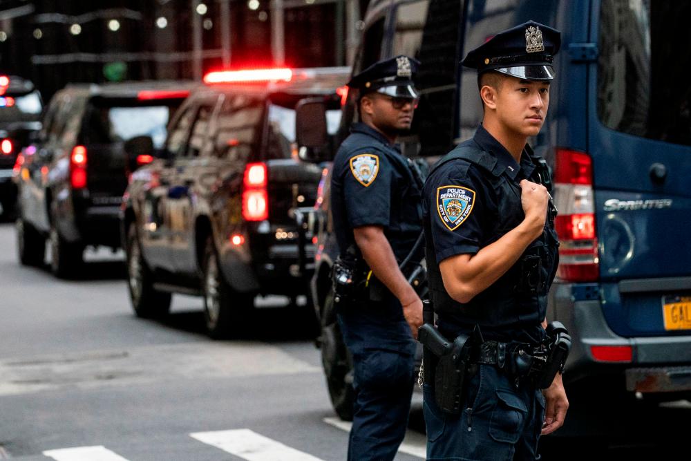 New York City Police (NYPD) officers stand guard as a motorcade transporting former U.S. President Donald Trump arrives to the General Attorney offices in the borough of Manhattan in New York City, New York, U.S., August 10, 2022. REUTERSPIX