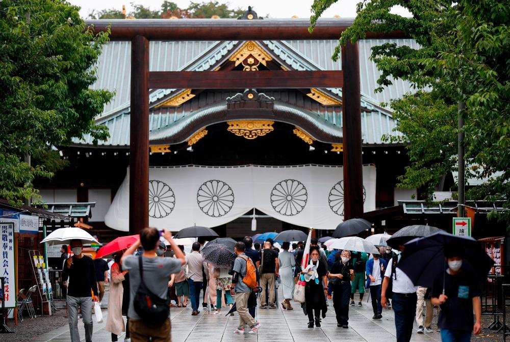 People carry umbrellas as they visit Yasukuni Shrine in Tokyo, Japan/REUTERSPix