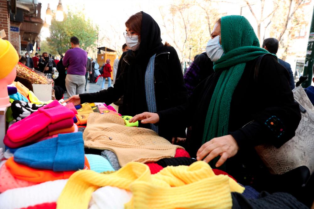 FILE PHOTO: Women shop at a street in Tehran, Iran, November 29, 2021. Majid Asgaripour/WANA - REUTERSPIX