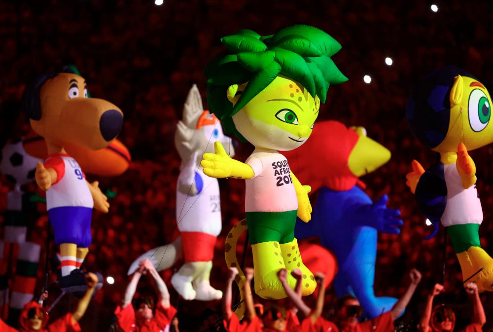 $!General view of inflatable mascots of previous World Cups during the opening ceremony. – REUTERSPIX