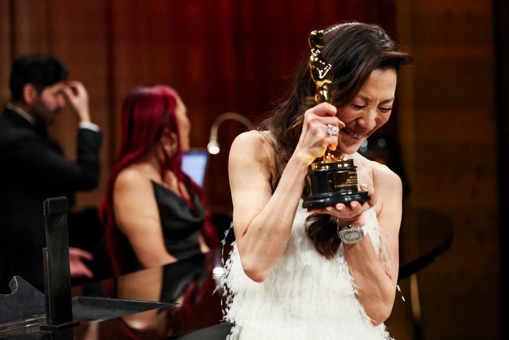 FILE PHOTO: Best actress Michelle Yeoh reacts after having her Oscar engraved at the Governors Ball following the Oscars show at the 95th Academy Awards in Hollywood, Los Angeles, California, U.S., March 12, 2023. - REUTERSPIX