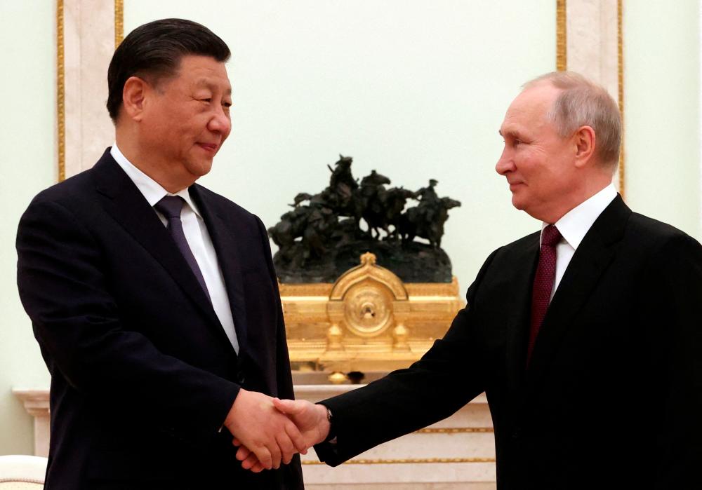 Russian President Vladimir Putin shakes hands with Chinese President Xi Jinping during a meeting at the Kremlin in Moscow, Russia, March 20, 2023/AFPPix