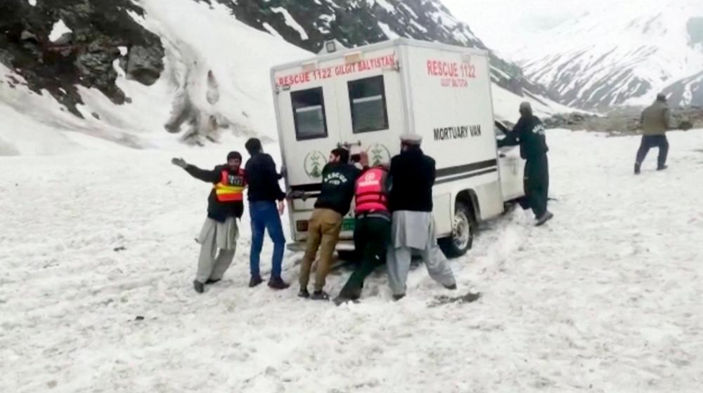 Rescuers push a mortuary van through the snow after an avalanche killed members of a nomadic tribe, in Astore, Pakistan May 27, 2023 in this screen grab from a video. - REUTERSPIX
