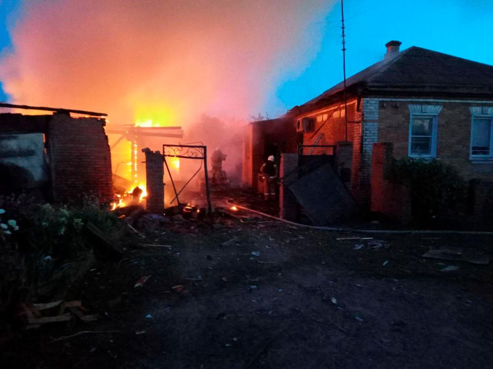 Firefighters work at a house on fire following a shelling, which, according to the regional governor, was by Ukrainian forces, in the village of Sobolevka, Belgorod region, Russia. REUTERSPIX