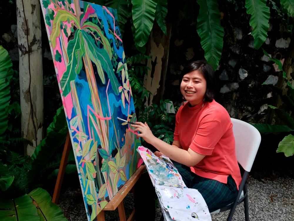Wong painting in her garden. – COURTESY OF LISA WONG